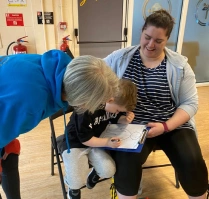 Natalie helping parent and child